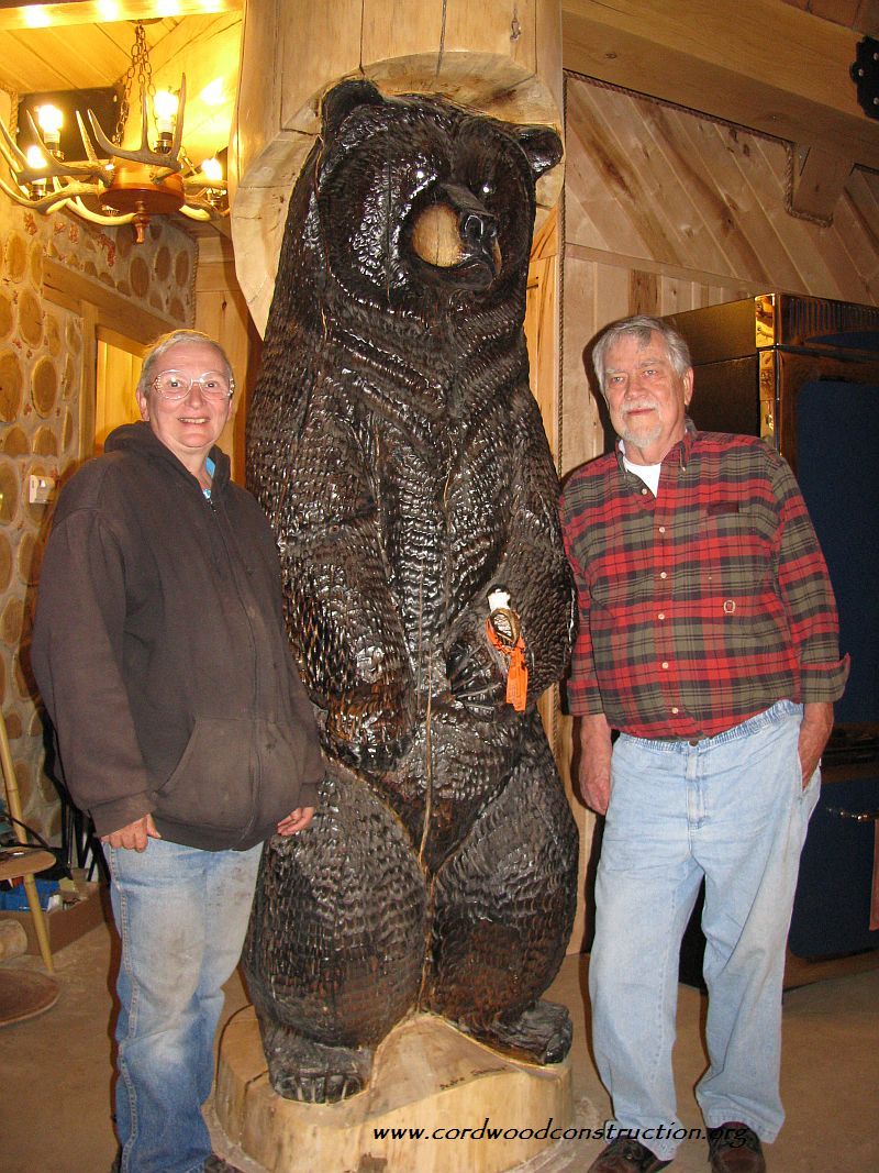 George Beveridge (with Paulette and Wayne Higgins) UP of MI with chain saw carving by Grizz Works of Maple, WI