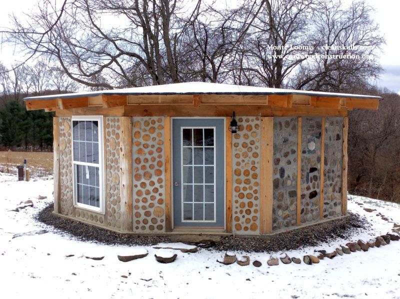 Cordwood Cabin with a Rock Wall & Cordwood Tables